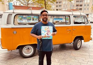 Mo Hersi staat voor een oranje bus